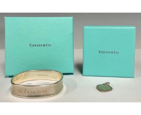 A Tiffany &amp; Co rounded square 925 silver bangle, 62mm diameter,  Tiffany &amp; Co Heart Tag pendant, both boxed (2)