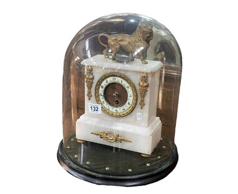 Victorian ornate gilt and onyx mantel clock with a lion crest under a glass dome, 40cm high.