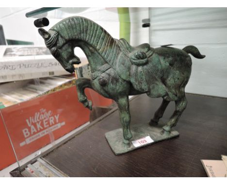 A vintage metal cast Tang dynasty horse figure with marks to base