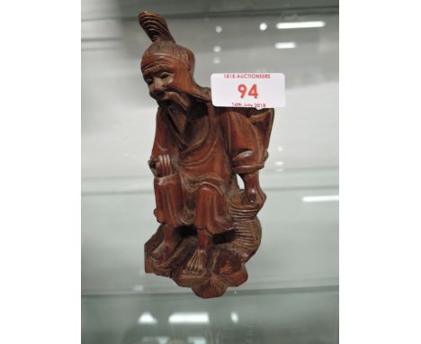 A vintage fisherman figure hand carved possibly Chinese