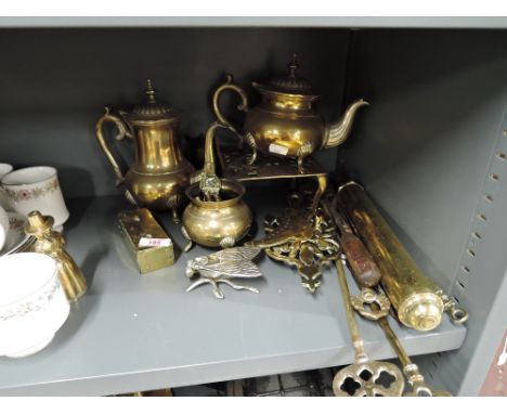 A selection of vintage brass and similar items including fire pokers flat iron stands etc