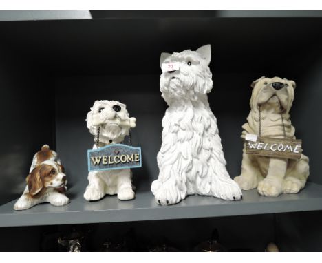 A selection of vintage resin cast and similar dog figures including white westie highland dog