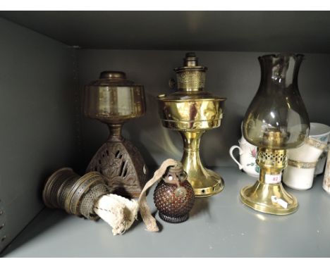 A selection of vintage oil lamps and bases including glass well and brass base