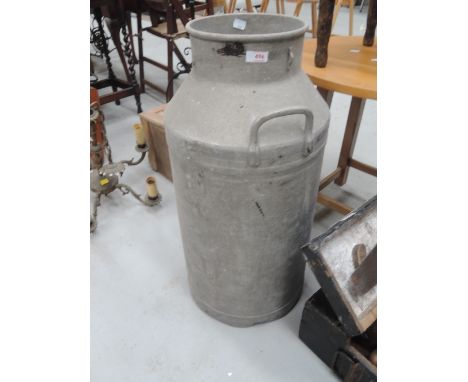 A vintage aluminium churn