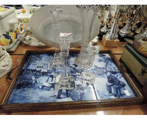 A butlers tray with blue and white tile decoration, a vase and three glass candlestick