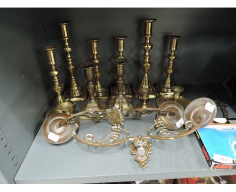 A selection of vintage brass and similar candle sticks including wall mounted duet set