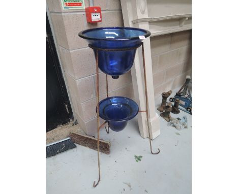 A modern planter with blue bohemian glass wells