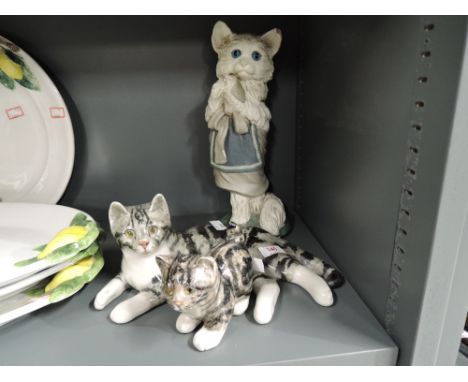 A selection of vintage cat figures including cat with clothes on