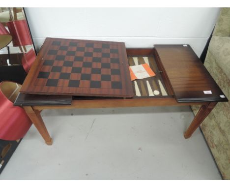 A modern mahogany games / coffee table with backgammon/chequer board top etc 