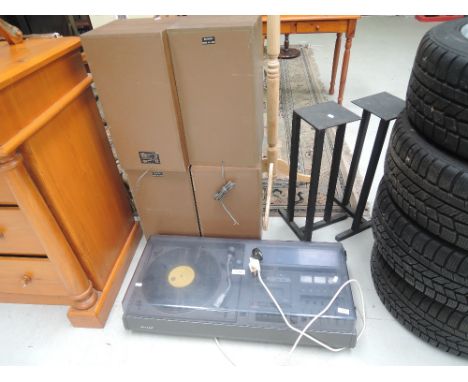 A vintage Sharp hifi centre, two pairs of speakers and one pair of speaker stands