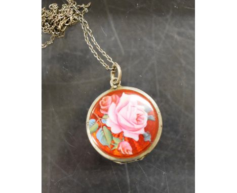 A white metal and enamel locket on chain, the enamel decorated with a rose