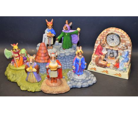 A Royal Doulton Bunnykins King Arthur group, including Merlin, Queen Guinevere, Sir Galahad, stand, others; a Royal Doulton B