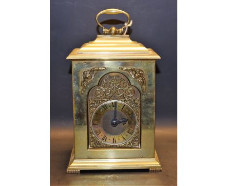 A heavy brass 'bracket' mantel clock, glass side panels
