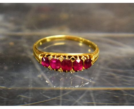 A ruby and diamond line ring, five stone, 3.1g gross