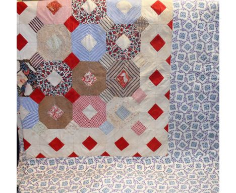 A patchwork bedcover, geometric design in plain and printed cotton, floral print border, cotton backed, c 1900, approximately