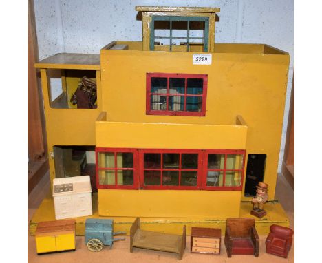 A 1930's two story dolls house, flat roof, hinged door, containing assorted furniture; etc 