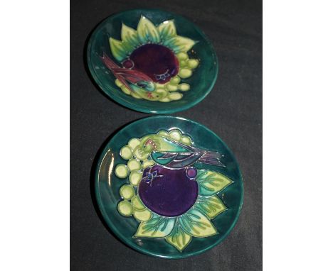 Pair of Moorcroft tube lined parakeet and fruit trinket dishes, D ~ 12cm 
