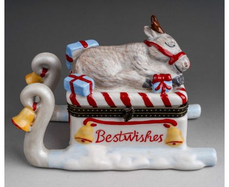 A Villeroy &amp; Boch porcelain Christmas trinket box, modelled as Rudolph the reindeer sleeping on top of a sledge, hinged l