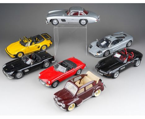 A collection of seven die cast 1/18 model cars to include: Minichamps Mercedes-Benz 300 SL; UT Models McLaren; Revell Porsche