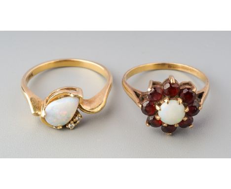 Two gem-set rings, to include a pear-shape opal cabochon dress ring with single cut diamond accents, stamped 10k, approximate