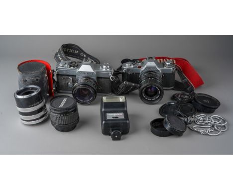 A collection of Canon cameras and lenses including Canon AV-1 camera with 35 - 70mm / F3.5/4.5 lens, a Canon FTb camera with 