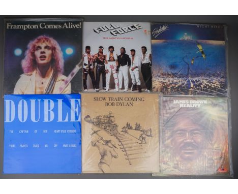An LP case containing singles, LPs and vintage records, the LPs include Bob Dylan - Slow Train Coming, Peter Frampton - Framp