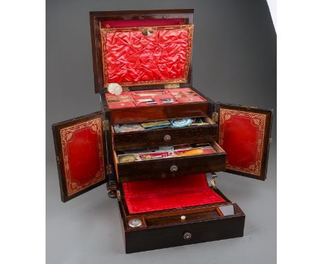 A Victorian rosewood table top sewing cabinet, hinged caddy top with mother of pearl cartouche, the pink silk lined interior 