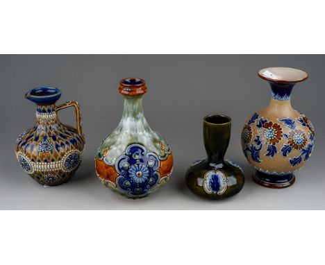 Four pieces of late 19th and early 20th century Doulton stoneware, including a Lambeth jug with incised scale design and bead