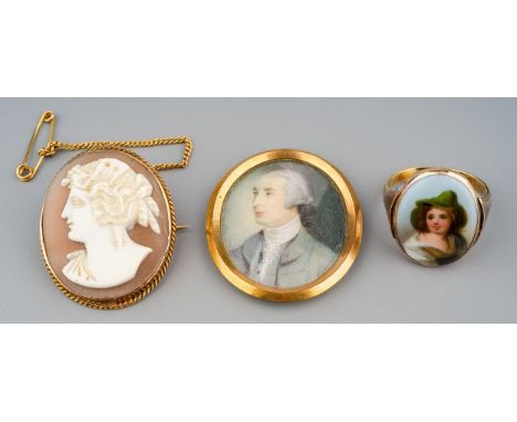 A Victorian yellow metal cameo brooch; a 9ct yellow gold ring, set with a continental porcelain plaque painted with a portrai