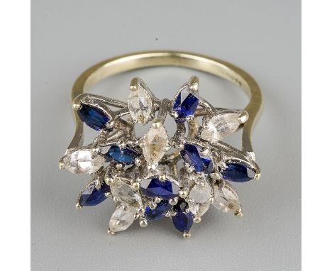A 9ct white gold gem set ring, set with synthetic blue sapphire and colourless spinel, to the plain band, hallmarked 9ct gold