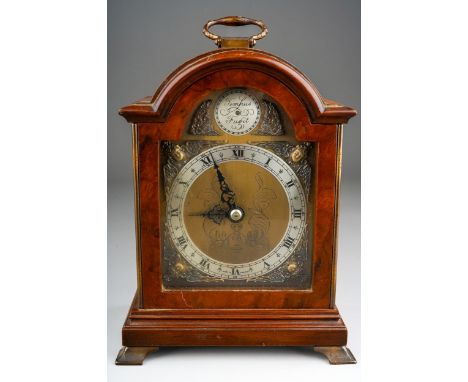 A Modern English simulated walnut mantle clock, brass dial with Roman numerals stamped An Elliot Clock, with carrying handle