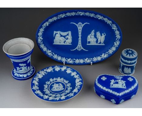 Five Wedgwood blue jasparware items to include; oval dish, heart shaped ring box and cover; a posy vase; circular dish and bo