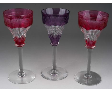 Three John Walsh coloured crystal ogee shaped wine glass with vine leaf and grapes etched border, 2 x ruby glass and 1 x amet