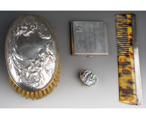 An Art Nouveau silver mounted oval brush, the cover embossed with flowers, hallmarked by William Comyns, London, 1904 togethe