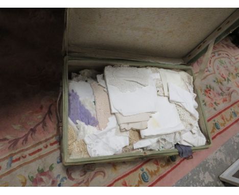 A GREEN CABIN TRUNK CONTAINING A LARGE QUANTITY OF NEEDLE WORK AND LINEN 