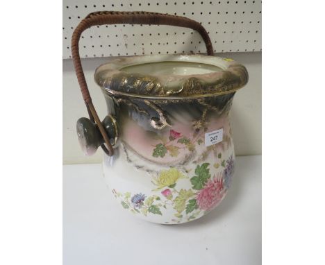 A VINTAGE CERAMIC DRAINING POT WITH WICKER WORK HANDLE 