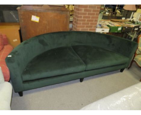 A LARGE MODERN CURVED GREEN SOFA