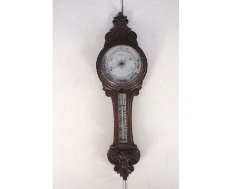 A late Victorian oak cased aneroid barometer with retailers mark for Benn Franks, Hull, Middlesbro., 87cm high
