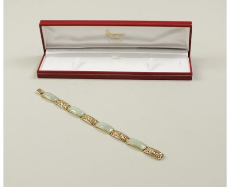 A 9ct gold jade panel bracelet, designed as four rectangular jade panels interspersed with four 9ct gold pierced openwork pan