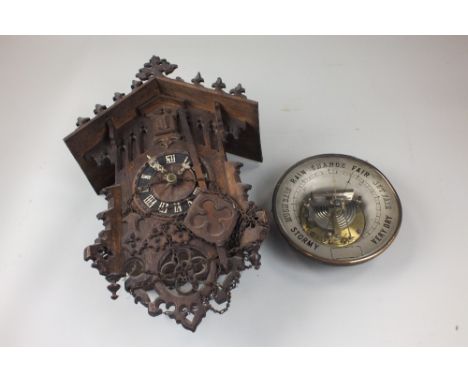 An Austrian oak cased cuckoo clock with typical moulded case and pine cone weights together with an early 20th century brass 
