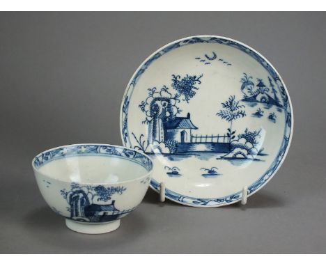 A Lowestoft porcelain tea bowl and saucer painted with a Chinese River Scene, circa 1765, with a lattice and floral border, u