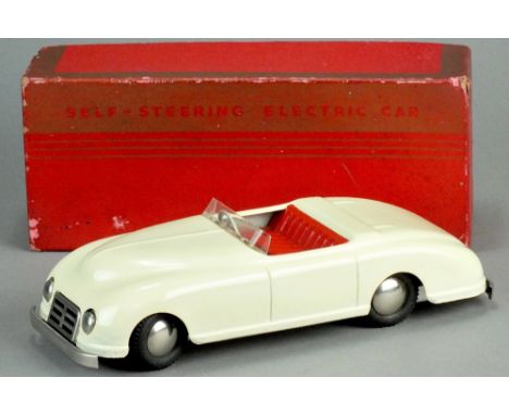 A vintage tin plate Harold Flory Products, battery operated 'self steering electrical car' 26cm cream with red interior, rubb