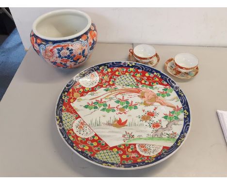 A 20th century Japanese charger, together with a Japanese Imari jardiniere and a pair of cups and saucers Location: RAB 