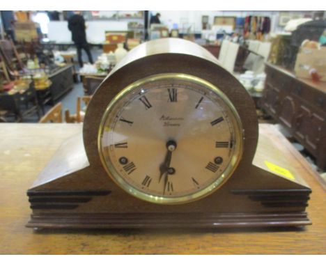 A 1930's J.W. Benson wooden cased mantel clock with ebonized mounts, silvered Roman dial, the movement striking on Westminste