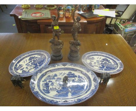 A pair of late 19th century spelter figures, three ebony model elephants and three blue and white meat plates 