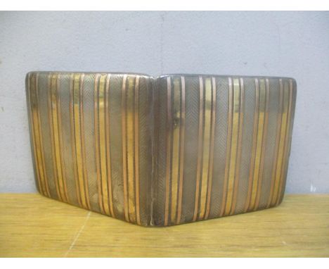 An early 20th century silver and gold engine turned cigarette case hallmarked Birmingham 1928, 114.6g, A/F latch is broken 