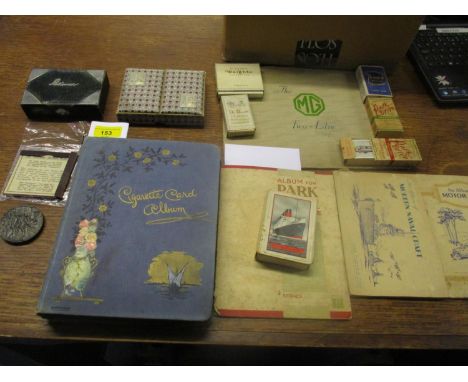 A mixed lot to include a Lusitania medal, cigarette cards, some in albums, playing cards including a green leather and silver