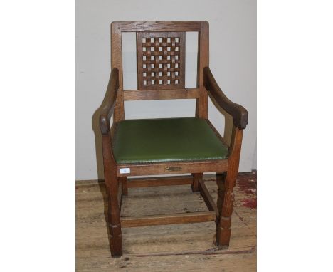 A Robert 'Mouseman' Thompson oak adzed carver chair with lattice work back panel and trademark carved mouse to one leg. Has a