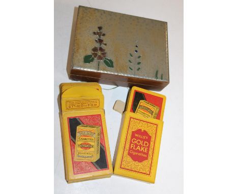 A wooden box containing two sets of vintage playing cards 