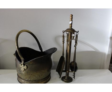 A vintage brass coal bucket and fireside tools 